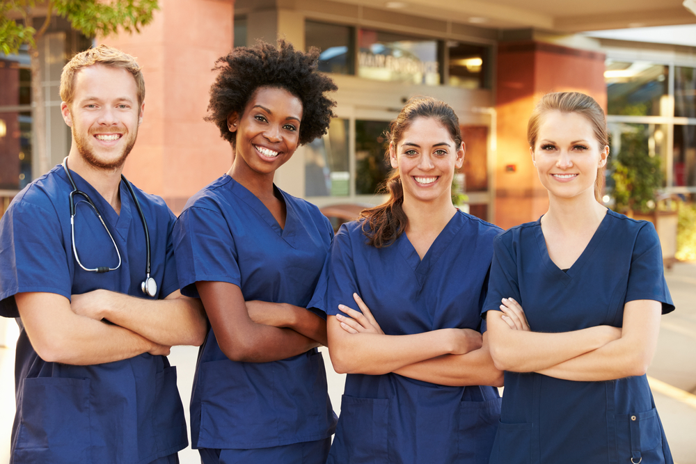 nurses standing outside of hospital