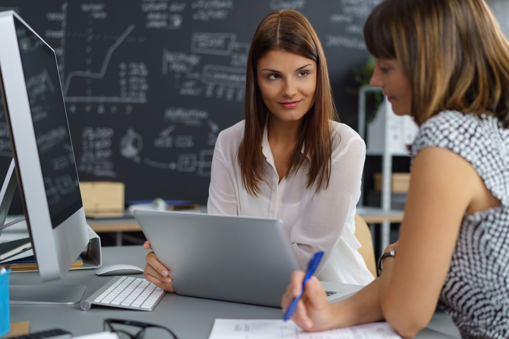 women discussing business at table