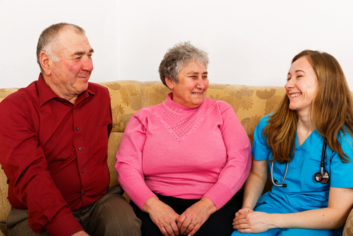 younger woman sitting with older couple