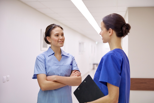 nurse speaking with doctor